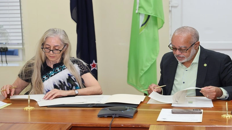 Ambassador Linda Te Puni and Dr. Didacus Jules signing the partnership agreement