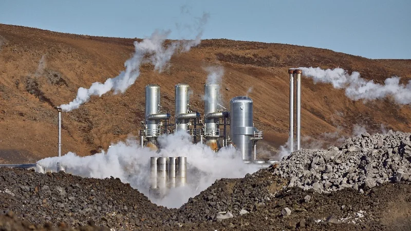 Geothermal power plant with mountains in the background