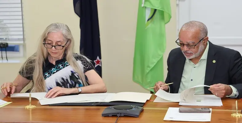 Ambassador Linda Te Puni and Dr. Didacus Jules signing the partnership agreement