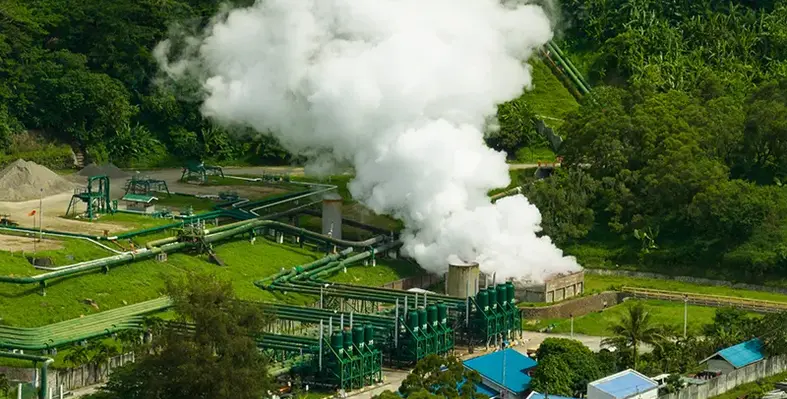 Geothermal_power_production_plant_with_steam_and_pipes