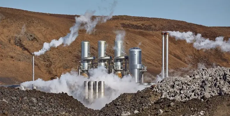 Geothermal power plant with mountains in the background